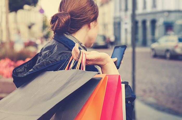 woman with shopping bags in hand