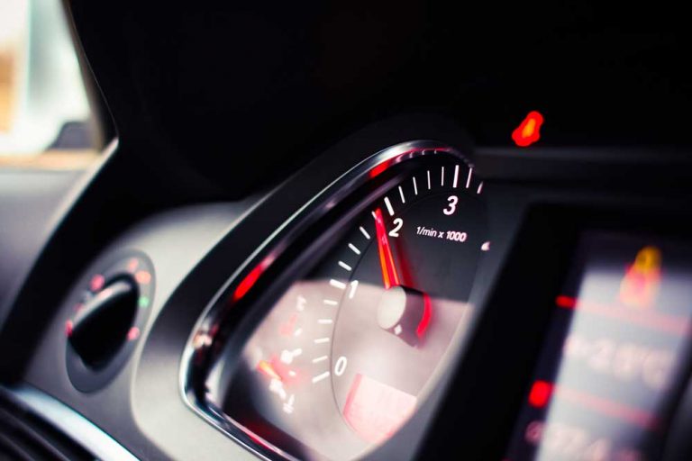 speedometer on car dashboard representing customer experience metrics giving key insights